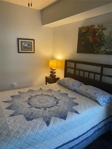a bedroom with a bed and wall painting