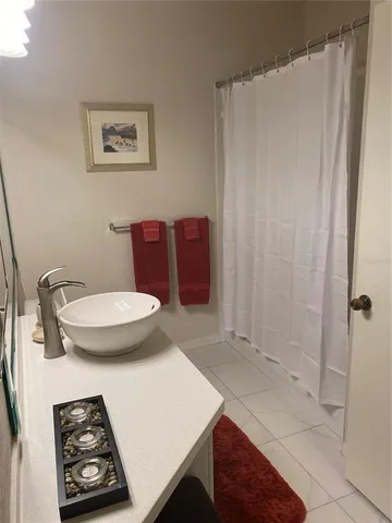 a bathroom with a toilet a sink and shower