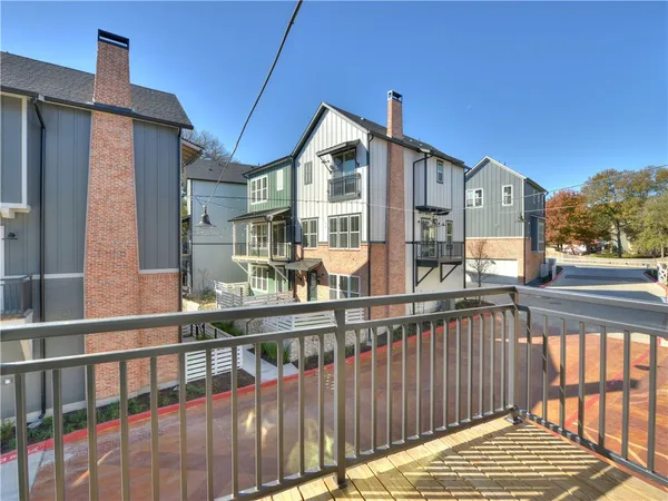 a view of kitchen with kitchen island a sink wooden floor and a refrigerator