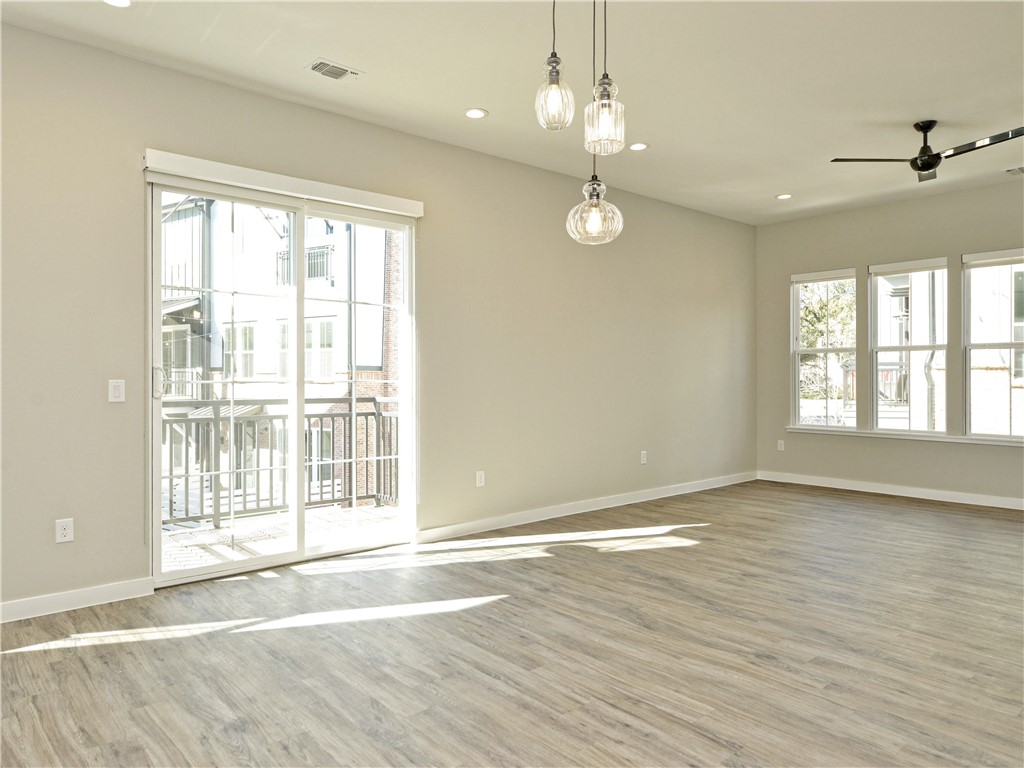 3809 Valley View Road, Unit 15 Austin, TX 78704 - Photo 13 of 30 a view of an empty room with wooden floor and a window