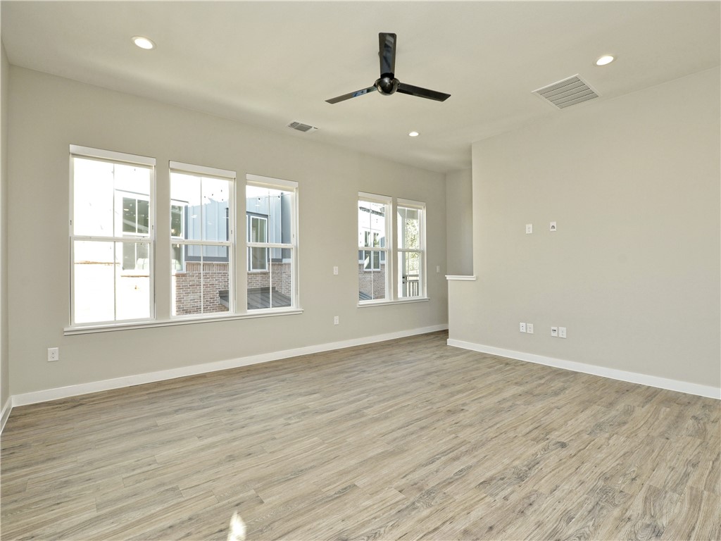 3809 Valley View Road, Unit 15 Austin, TX 78704 - Photo 14 of 30 a view of an empty room with wooden floor and a window
