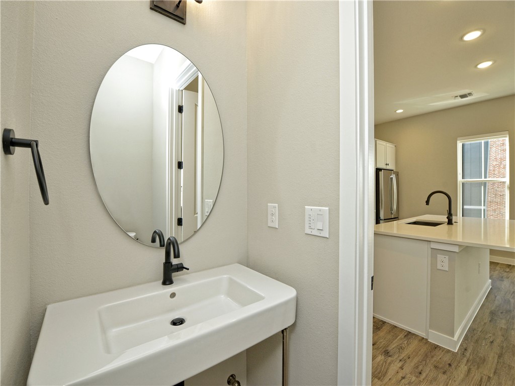 3809 Valley View Road, Unit 15 Austin, TX 78704 - Photo 16 of 30 a bathroom with a sink a mirror and a toilet