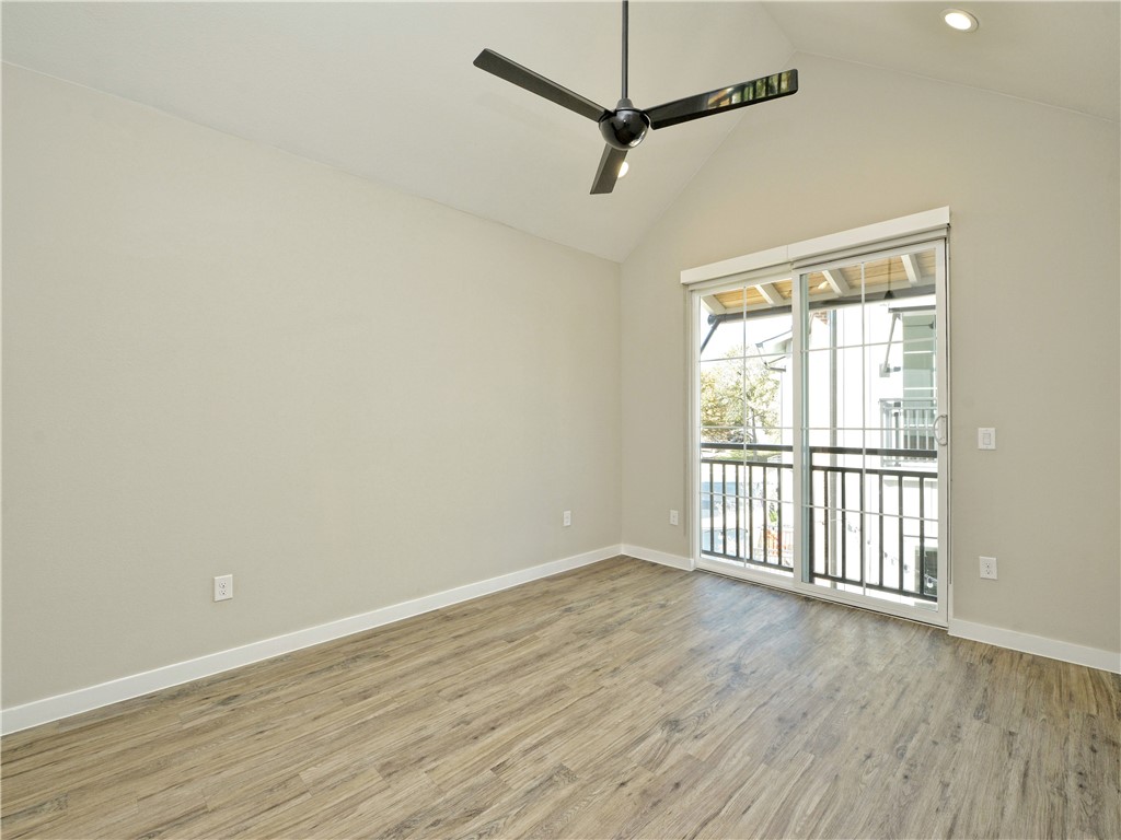 3809 Valley View Road, Unit 15 Austin, TX 78704 - Photo 19 of 30 a view of an empty room with wooden floor and a window