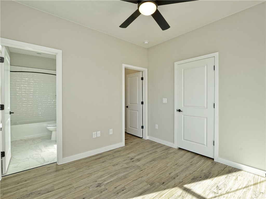 3809 Valley View Road, Unit 15 Austin, TX 78704 - Photo 23 of 30 an empty room with wooden floor cabinet and windows