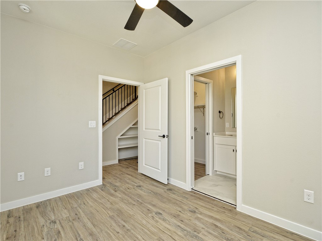 3809 Valley View Road, Unit 15 Austin, TX 78704 - Photo 25 of 30 an empty room with wooden floor closet and windows