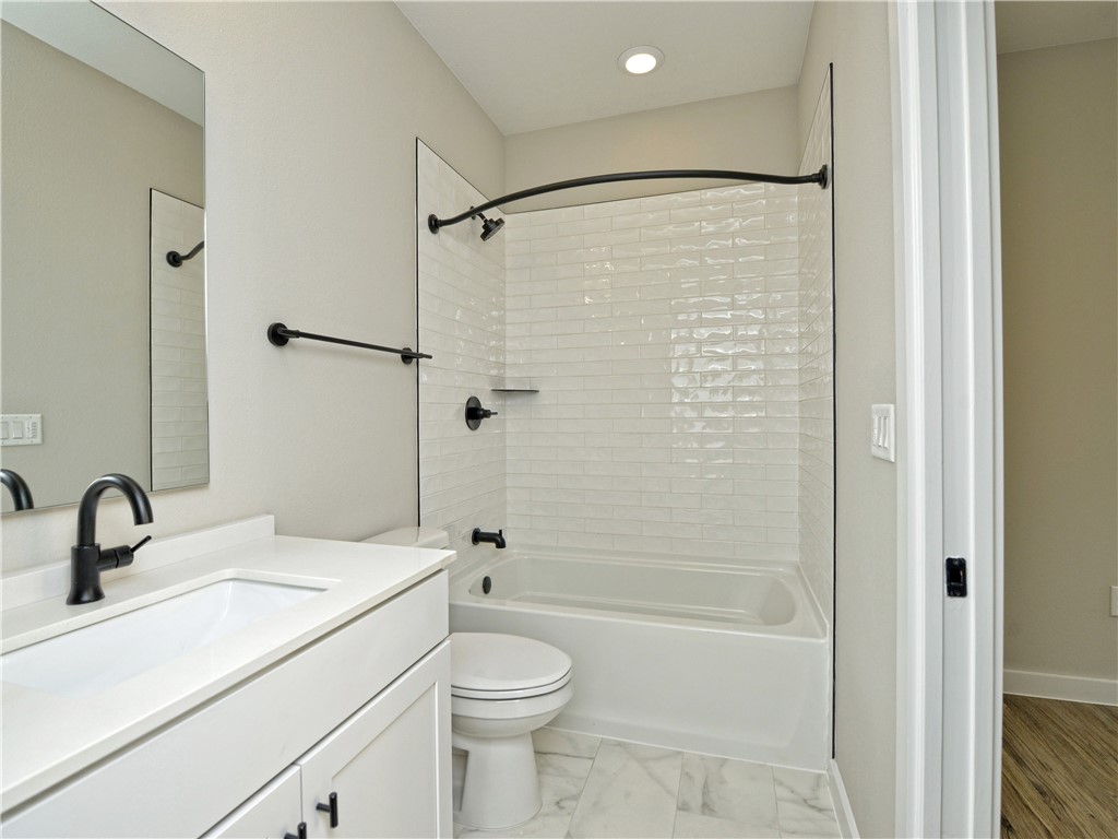 3809 Valley View Road, Unit 15 Austin, TX 78704 - Photo 27 of 30 a bathroom with a sink a toilet and shower