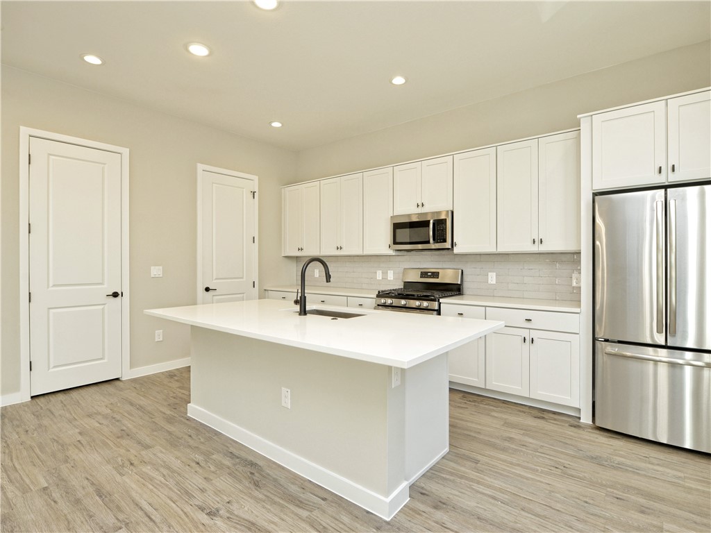 3809 Valley View Road, Unit 15 Austin, TX 78704 - Photo 7 of 30 a kitchen with appliances a sink and a refrigerator