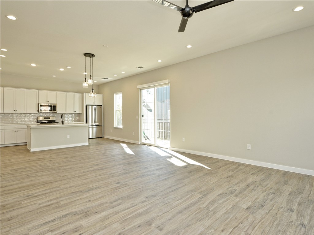 3809 Valley View Road, Unit 15 Austin, TX 78704 - Photo 9 of 30 a view of a kitchen with a refrigerator and a stove top oven