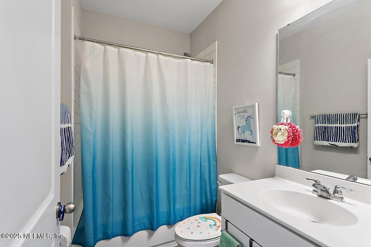 367 Brookgreen Way St. Augustine, FL 32092 - Photo 11 of 27 a bathroom with a sink a toilet and shower curtain