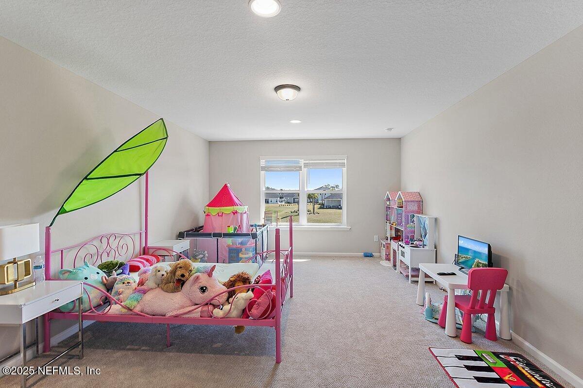 367 Brookgreen Way St. Augustine, FL 32092 - Photo 13 of 27 a bedroom with toys and a couch