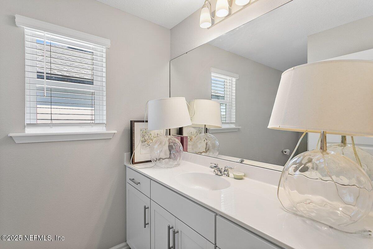 367 Brookgreen Way St. Augustine, FL 32092 - Photo 14 of 27 a bathroom with a sink and a mirror