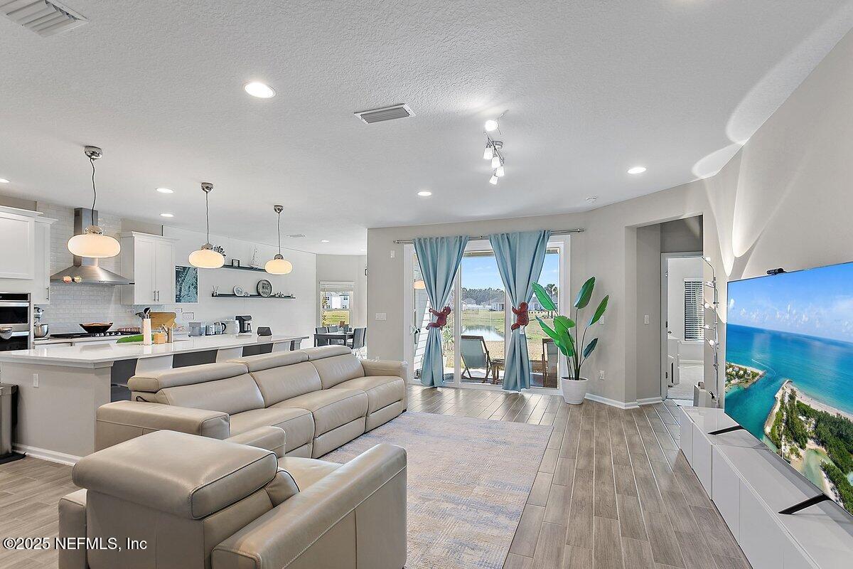 367 Brookgreen Way St. Augustine, FL 32092 - Photo 3 of 27 a living room with furniture kitchen view and a large window