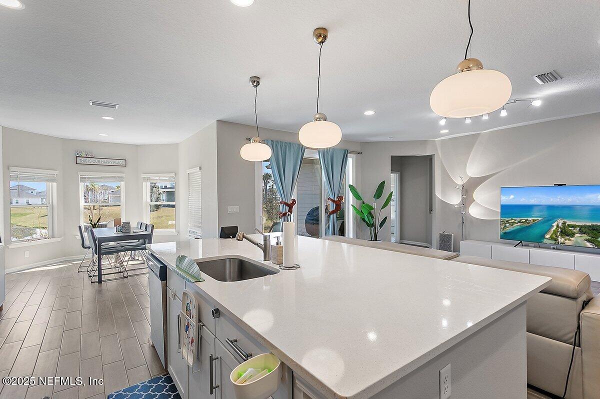 367 Brookgreen Way St. Augustine, FL 32092 - Photo 5 of 27 a large kitchen with stainless steel appliances a large center island attached withe living room