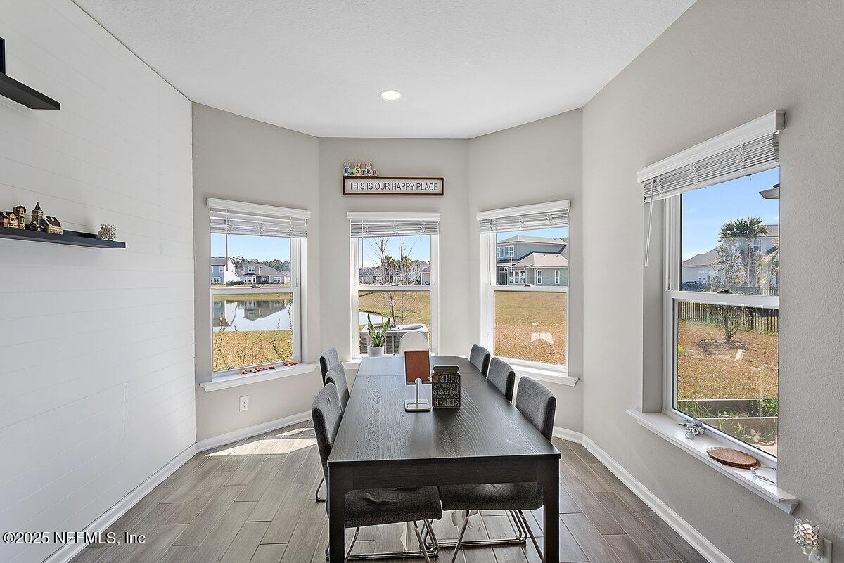 367 Brookgreen Way St. Augustine, FL 32092 - Photo 6 of 27 a view of a dining room with furniture a rug and wooden floor