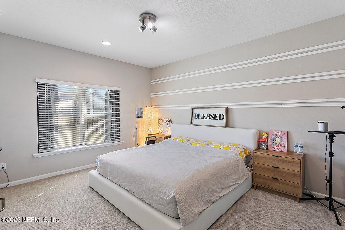 367 Brookgreen Way St. Augustine, FL 32092 - Photo 7 of 27 a bedroom with a bed and a window