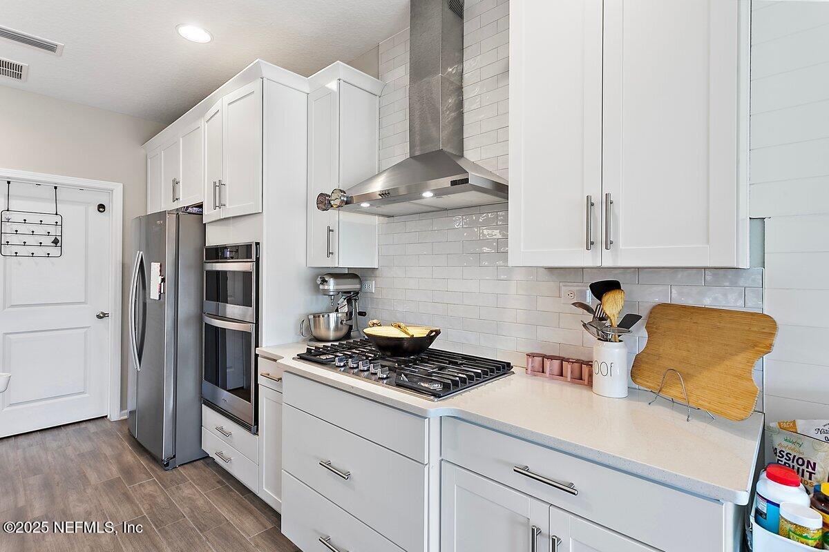 367 Brookgreen Way St. Augustine, FL 32092 - Photo 8 of 27 a kitchen with stainless steel appliances granite countertop a sink a stove a refrigerator and white cabinets