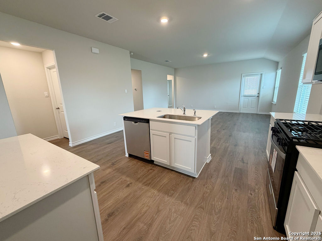 607 Fluted Cibolo, TX 78108 - Photo 15 of 50 a kitchen with a sink and wooden floor