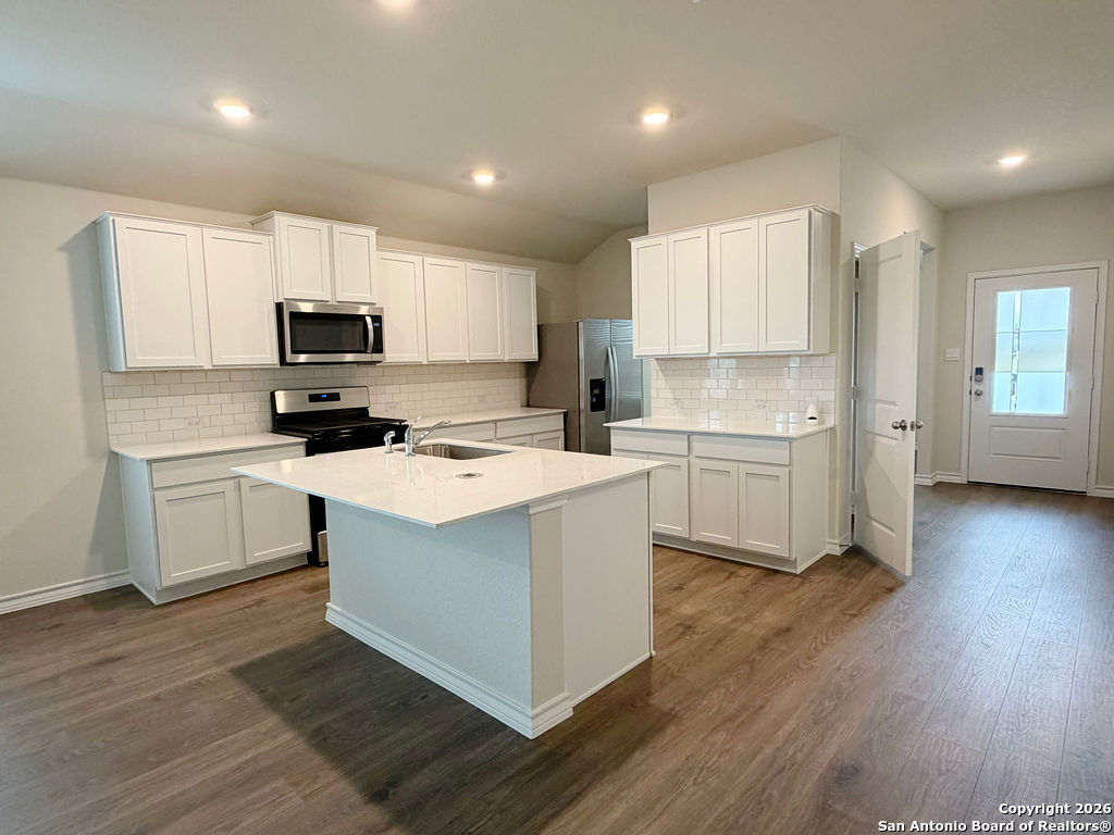 607 Fluted Cibolo, TX 78108 - Photo 27 of 50 a kitchen with a sink cabinets and wooden floor