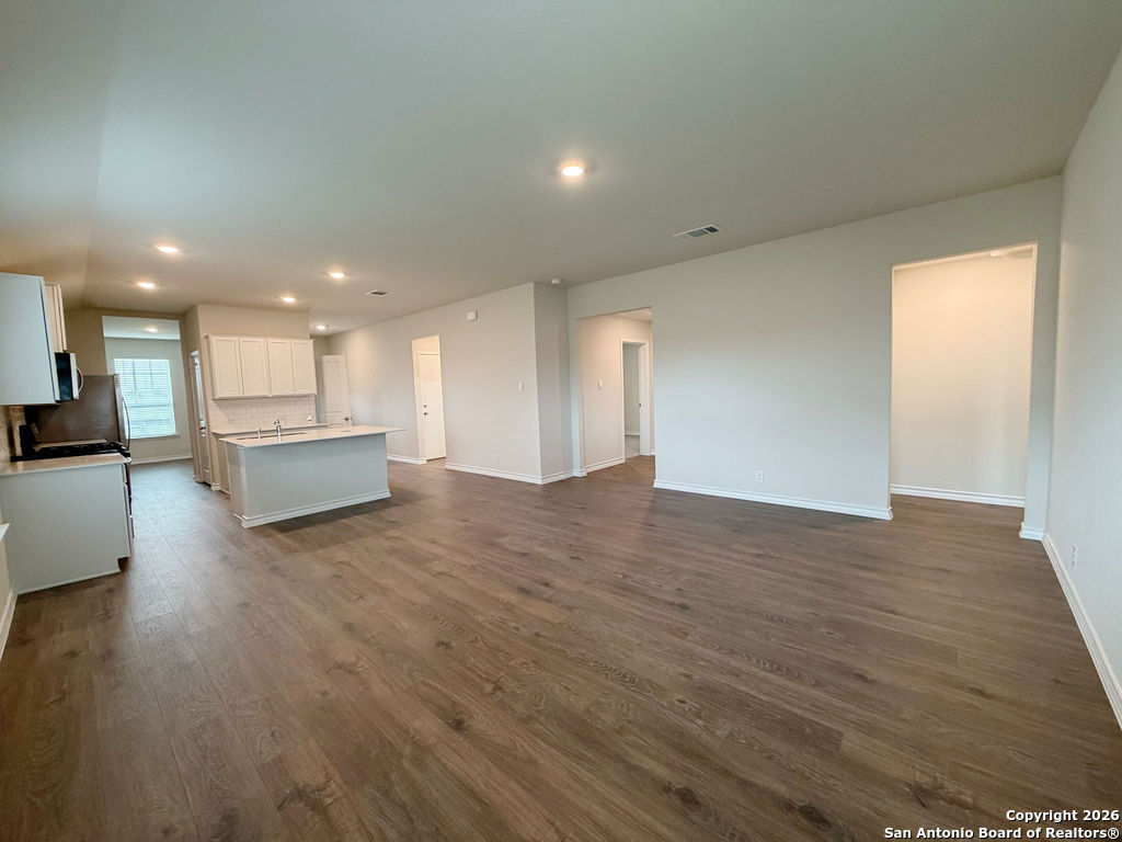 607 Fluted Cibolo, TX 78108 - Photo 31 of 50 a view of kitchen and hall with wooden floor