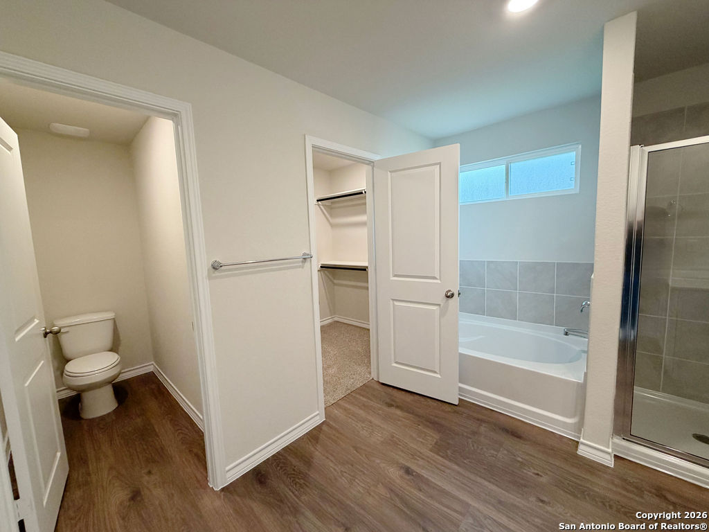 607 Fluted Cibolo, TX 78108 - Photo 36 of 50 a bathroom with a bathtub and a toilet