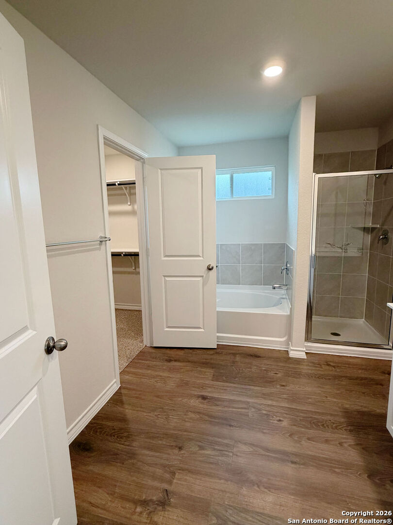 607 Fluted Cibolo, TX 78108 - Photo 40 of 50 an empty room with wooden floor and windows
