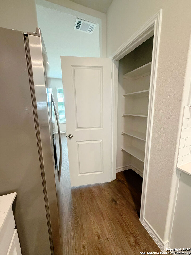 607 Fluted Cibolo, TX 78108 - Photo 8 of 50 a view of walk in closet with empty racks
