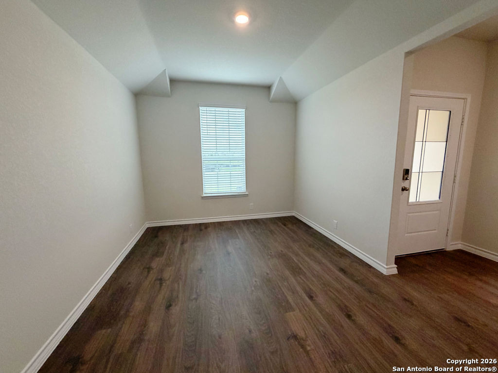 607 Fluted Cibolo, TX 78108 - Photo 9 of 50 an empty room with wooden floor and windows