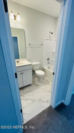 a swimming pool with an outdoor space and seating area