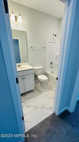 a swimming pool with an outdoor space and seating area