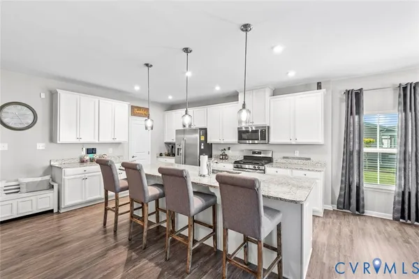 a large kitchen with a table and chairs