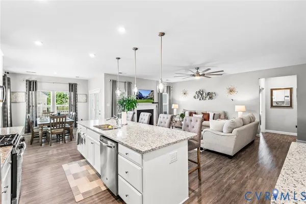 a living room with kitchen island furniture and a wooden floor