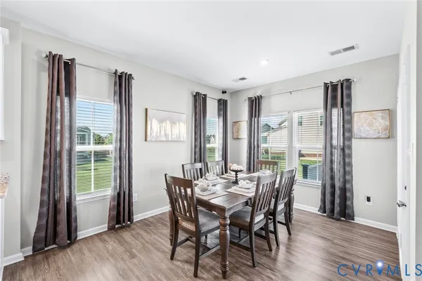 a view of a dining room with furniture and wooden floor
