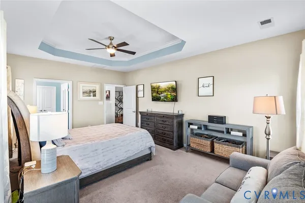 a bedroom with a bed furniture and a flat screen tv