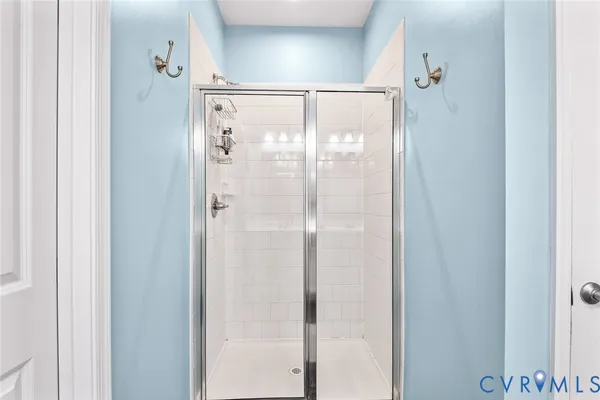 a bathroom with a glass shower door