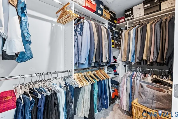 a view of walk in closet with clothes