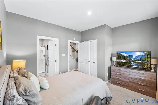 a bedroom with a bed and a couch