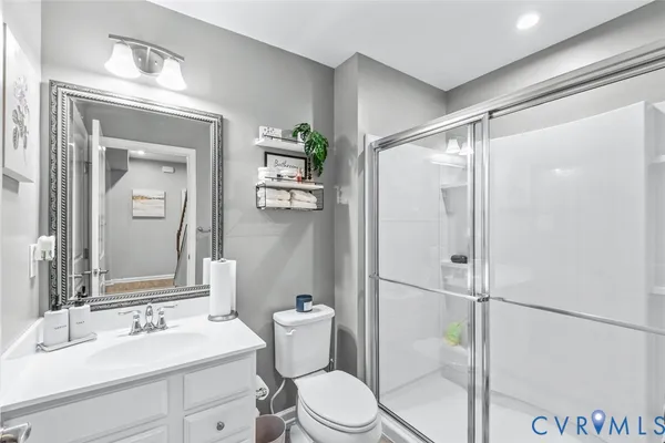 a bathroom with a toilet a sink and a mirror