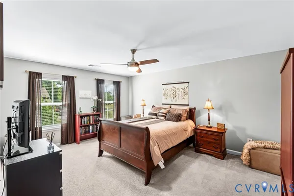 a bedroom with a bed and large window
