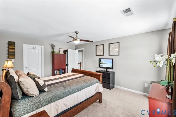 a bedroom with a bed couch and dresser