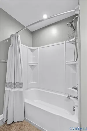 a bathroom with a shower and a tub