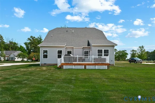 a view of a house with a yard and sitting area