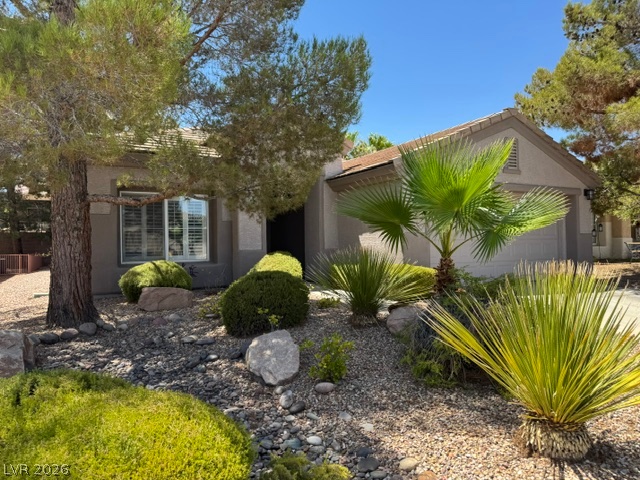 2189 Chapman Ranch Drive Henderson, NV 89012 - Photo 2 of 2 A well-maintained desert landscape frames this welcoming residence, hinting at tranquil living.