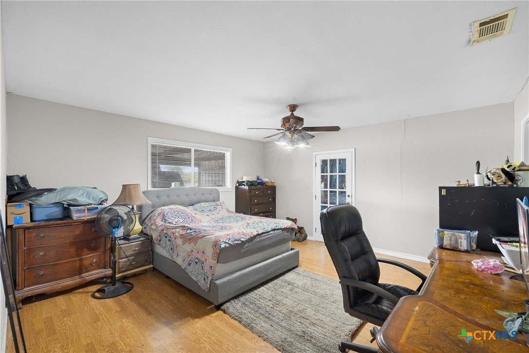 9765 State Park Road Lockhart, TX 78644 - Photo 20 of 40 a bedroom with a bed and a desk