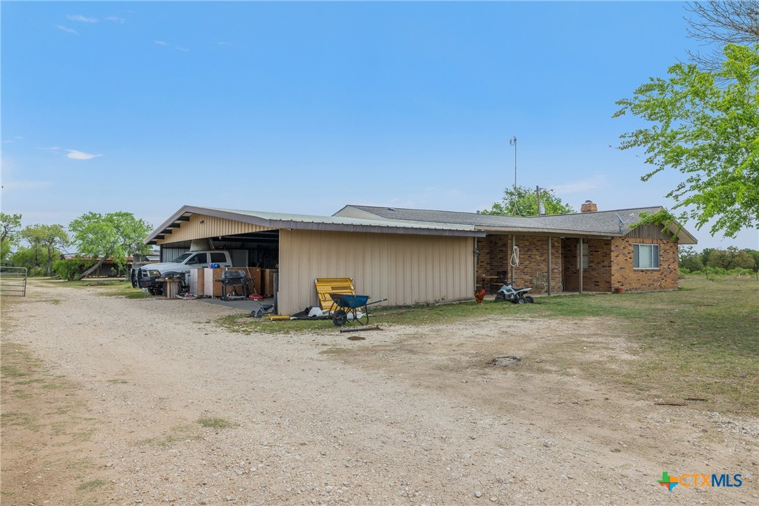 9765 State Park Road Lockhart, TX 78644 - Photo 6 of 40 a view of a house with a patio and a yard