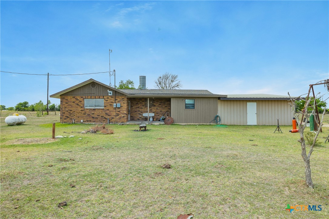 9765 State Park Road Lockhart, TX 78644 - Photo 8 of 40 a front view of the house with a garden