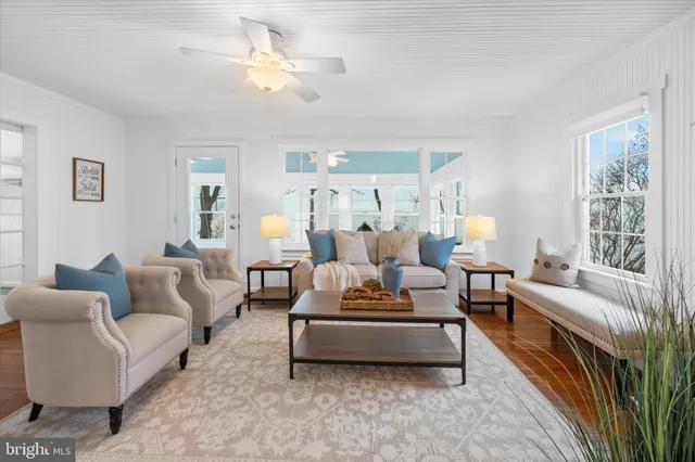 a living room with furniture a fireplace and paintings on the wall