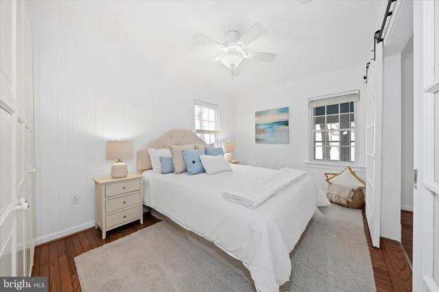 a bedroom with a white bed and white walls