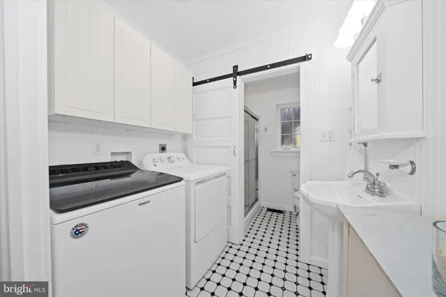 a white toilet sitting next to a bathroom sink and a shower