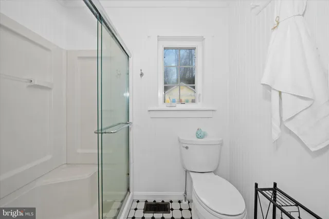 a bathroom with a glass shower door