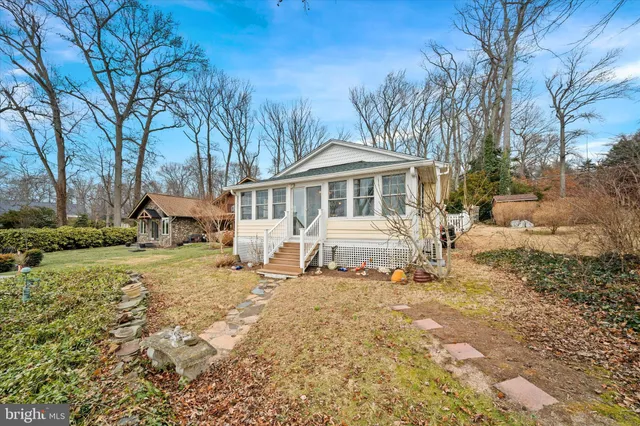 a white house that has a tree in front of it